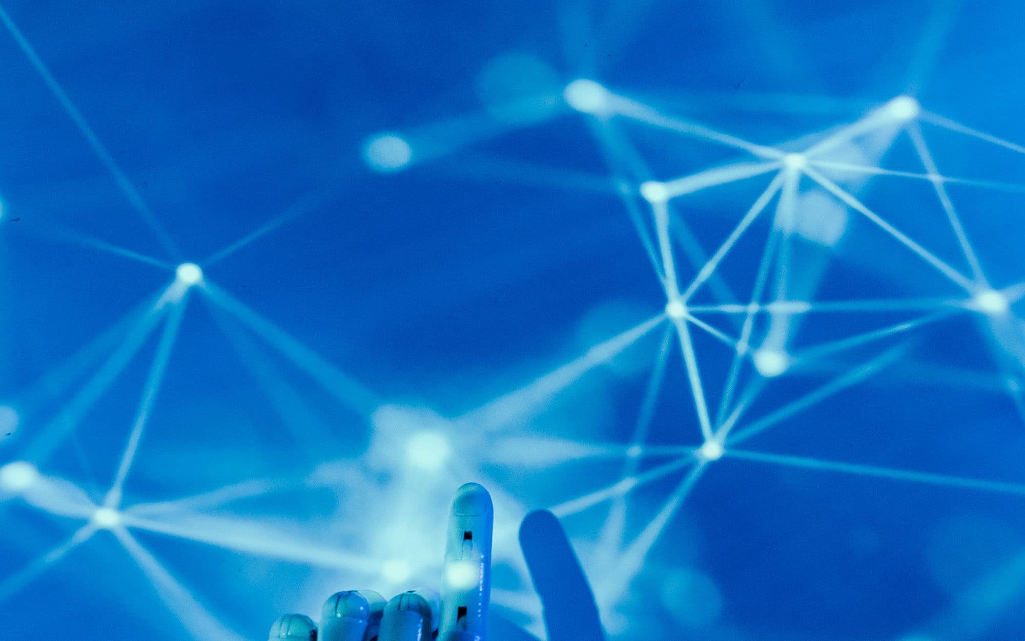 A robotic fingertip touching a glowing blue data network